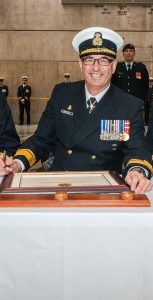 From left, outgoing CFB Halifax Base Commander Capt(N) Chris Sutherland, RAdm John Newton, and incoming Base Commander Capt(N) Paul Forget sign documents at the Change of Command ceremony held at HMCS Scotian on March 31. Cpl Tony Chand/FIS Halifax