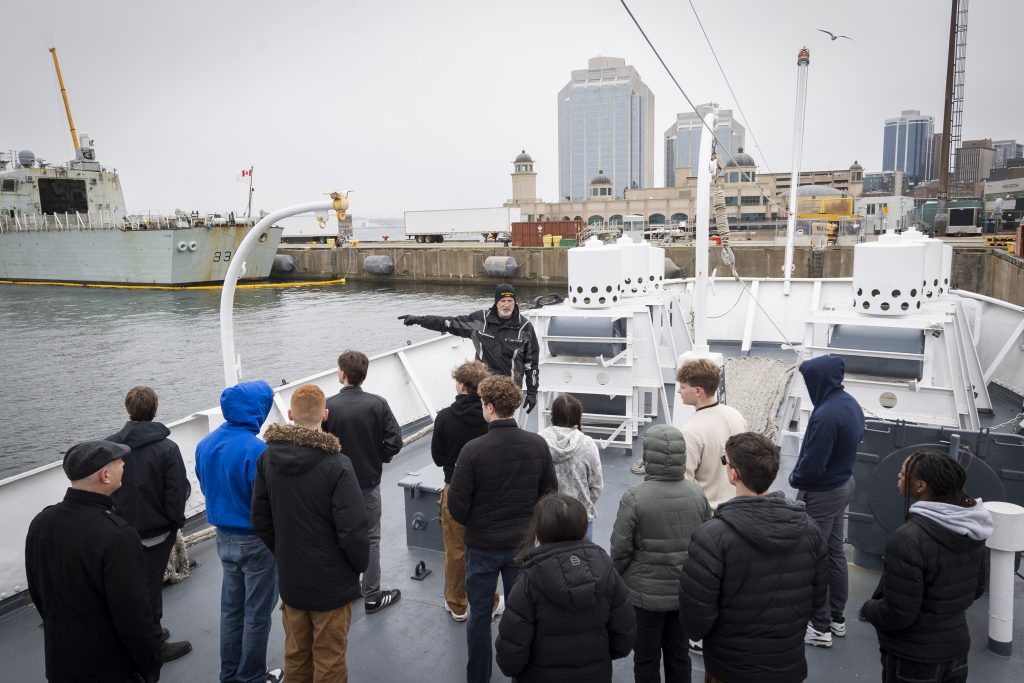 The 2025 Canadian Forces Base Halifax High School Navy Outreach Program students aboard His Majesty’s Canadian Ship Sackville. / Les élèves du Programme de sensibilisation de la Marine dans les écoles secondaires 2025 à bord du Navire canadien de Sa Majesté Sackville.